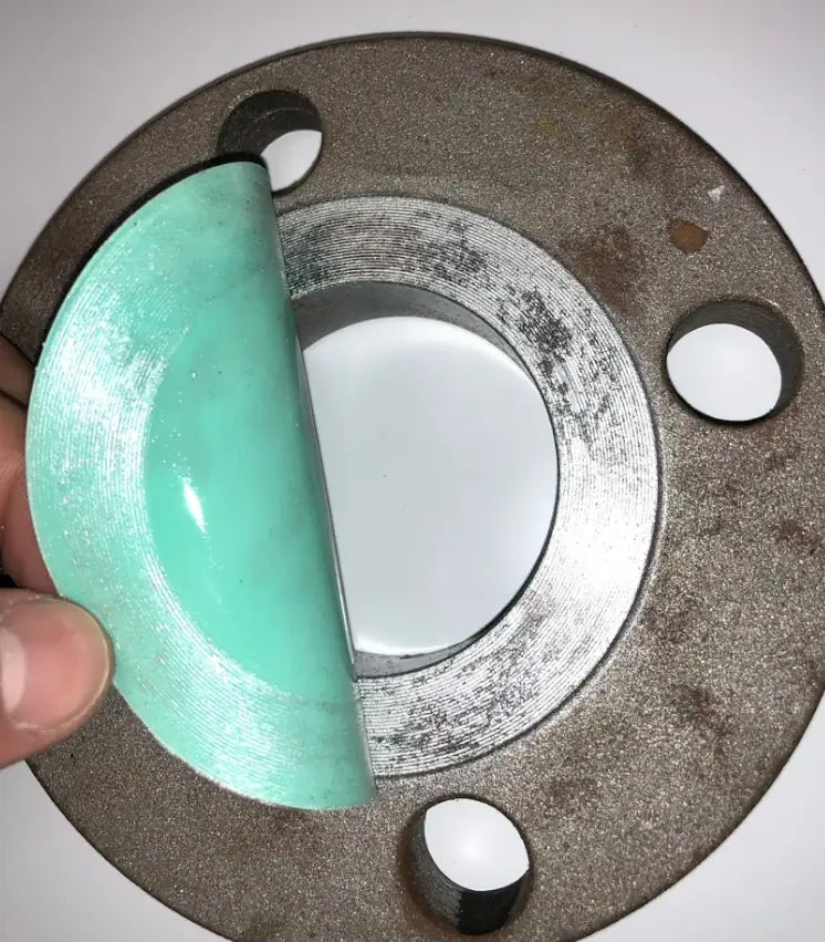 image of a blast guard being peeled off a flange face, leaving no residue behind